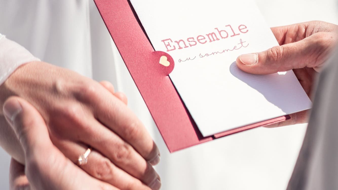 carnet de cérémonie laïque et couple qui se tient la main. avec alliance